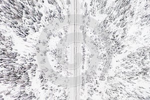 Aerial drone view of road in winter forest