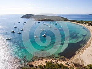 Aerial drone view of Rondinara Bay Beach Corsica with boats