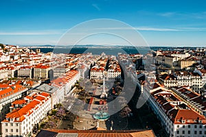 Aerial drone view of Rossio square, with the Tagus river in background in the Baixa district of Lisbon, Portugal