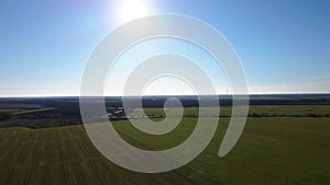 Aerial drone view of row of windmills in the field