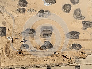 Aerial drone view of a sand mine in the forest. Loader Loading Sand Into Dump Truck In Sand Pit. Quarrying sand. Machines and photo