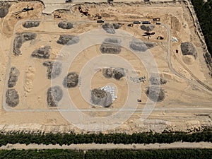 Aerial drone view of a sand mine in the forest. Loader Loading Sand Into Dump Truck In Sand Pit. Quarrying sand. Machines and photo