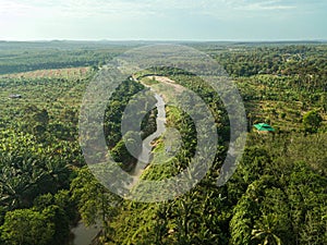 Aerial drone view of a small river at farmland in Jasin, Melaka, Malaysia