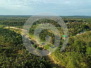 Aerial drone view of a small river at farmland in Jasin, Melaka, Malaysia