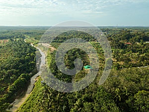 Aerial drone view of a small river at farmland in Jasin, Melaka, Malaysia