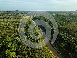 Aerial drone view of a small river at farmland in Jasin, Melaka, Malaysia