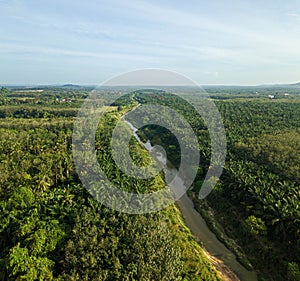 Aerial drone view of a small river at farmland in Jasin, Melaka, Malaysia