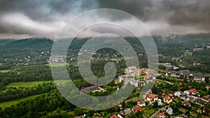 Aerial drone view, small typical polish villagesurrounded by beautiful mountains at summer