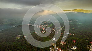 Aerial drone view, small typical polish villagesurrounded by beautiful mountains at summer