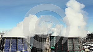 Aerial drone view of smoking pipes and cooling towers of coal thermal power plant. Thermal power station exhaust steam