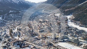 Aerial drone view of snow covered Chamonix city in the afternoon