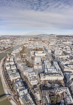 Aerial drone view of snowy Mirabelle Palace in Salzburg downtown center in winter morning