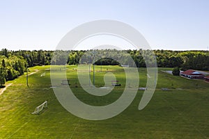 Aerial/Drone view of soccer/football field complex during the afternoon with shadows from clouds on the field in Ontario, Canada.