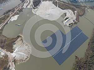 Aerial drone view on solar panels on water. Quarry and sand extraction. Sustainable innovations.