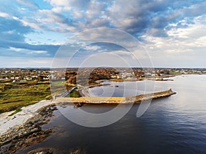 Aerial drone view on a Spiddal stone pier. County Galway, Ireland. Cloudy sky. Popular beach and walking spot and fishing location