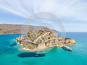 Aerial drone view of Spinalonga island with calm sea. Old venetian fortress island and former leper colony