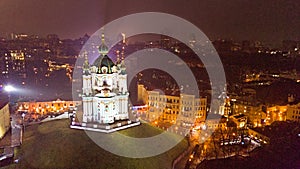 Aerial drone view of St Andrew`s Church in Kiev at night, Kyiv city skyline, Ukraine
