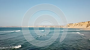 Aerial drone view of surfers beach, calm water and geology and typical vegetation of Angola