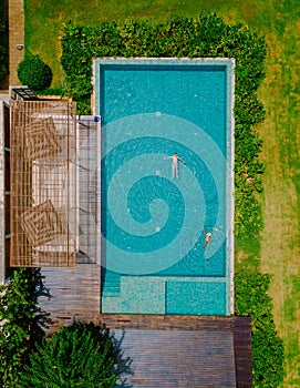 aerial drone view of swimming pool in the jungle of Krabi Thailand, aerial view with a drone above swimming pool during