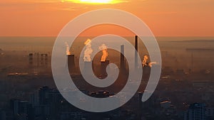 Aerial drone view of thermal power stations in Bucharest at sunset. Flying birds