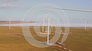 Aerial drone view to large wind turbines in field. Alternative energy