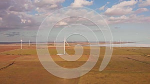 Aerial drone view to large wind turbines in field. Alternative energy