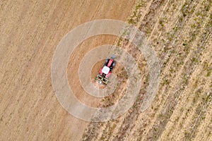 Aerial drone view of a tractor  plowing in a field