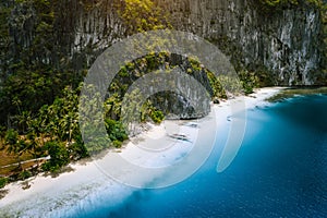 Aerial drone view of tropical exotic beach of Pinagbuyutan Island in El Nido. Amazing white sand beach and blue lagoon photo