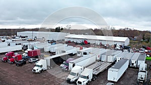 Aerial drone view of Truck repair shop, Service building and many trucks near it. USA, move camera to up