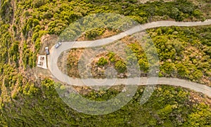 Aerial drone view of a twisty road on the countryside in Corfu Greece.