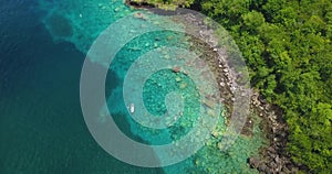 Aerial drone view of two people snorkelling in the tropical waters of the Caribbean sea