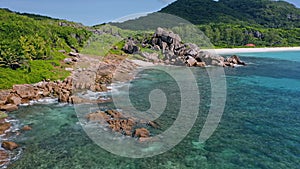 Aerial drone view of typical granite boulders and tropical coastline at La Digue island, Seychelles