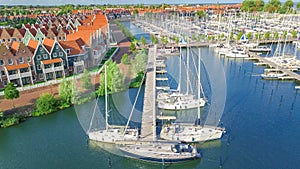 Aerial drone view of typical modern Dutch houses and marina in harbor, architecture of port of Volendam town, Holland, Netherlands photo