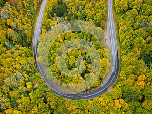 Aerial drone view of U Turn Road Curve in Autumn / Fall foliage overhead. Blue Ridge in the Appalachian Mountains near Asheville,