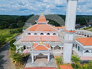 Aerial drone view of a white mosque known as Tun Khalil Mosque at Asahan, Melaka, Malaysia.