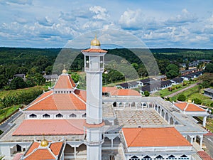 Aerial drone view of a white mosque known as Tun Khalil Mosque at Asahan, Melaka, Malaysia.