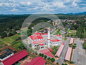 Aerial drone view of a white mosque known as Tun Khalil Mosque at Asahan, Melaka, Malaysia.