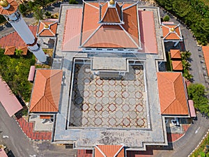 Aerial drone view of a white mosque known as Tun Khalil Mosque at Asahan, Melaka, Malaysia.