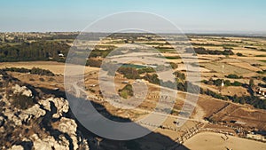 Aerial drone view of yellow fields in mountain wilderness desert area, harvest time in Cyprus