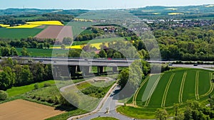 Aerial drone view of yellow rapeseed fields in German countryside