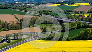 Aerial drone view of yellow rapeseed fields in German countryside