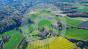 Aerial drone view of yellow rapeseed fields in German countryside