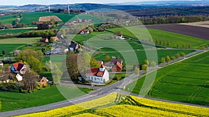 Aerial drone view of yellow rapeseed fields in German countryside