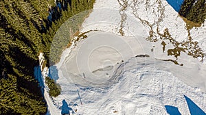 Aerial drop down view of frozen lake.