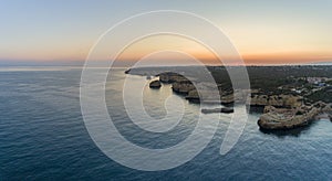 Aerial dusk seascape in Praia Albandeira, beach destination of Algarve coast. Portugal