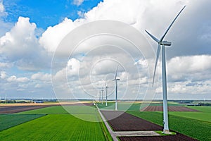 Aerial from a dutch landscape with windturbines, meadows and beautiful skies