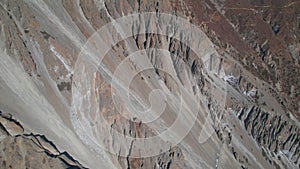 Aerial establishing shot of group of hikers on trail to Tilicho base camp in high himalaya mountains. Hiking adventure