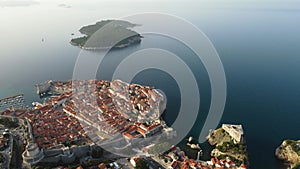 Aerial establishing view of old town of Dubrovnik with island on Adriatic sea, Dalmatia, Croatia. Medieval city fortress