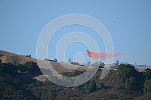 Aerial Firefighting Aircraft Dropping Fire Retardant photo