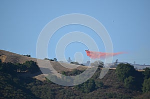 Aerial Firefighting Aircraft Dropping Fire Retardant photo